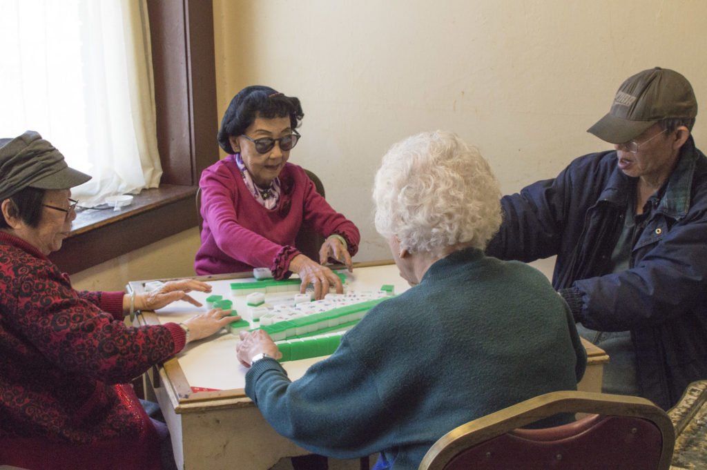 Residents in the common areas playing mahjong, a popular afternoon activity at the May Wah.